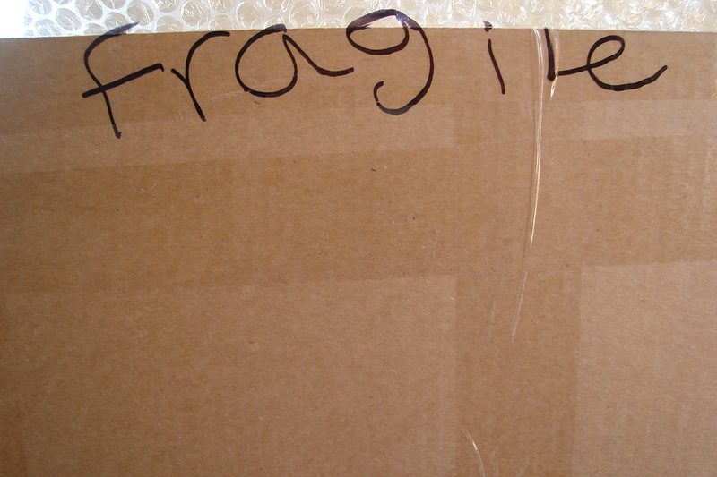 Parcel being sealed at a packing bench
