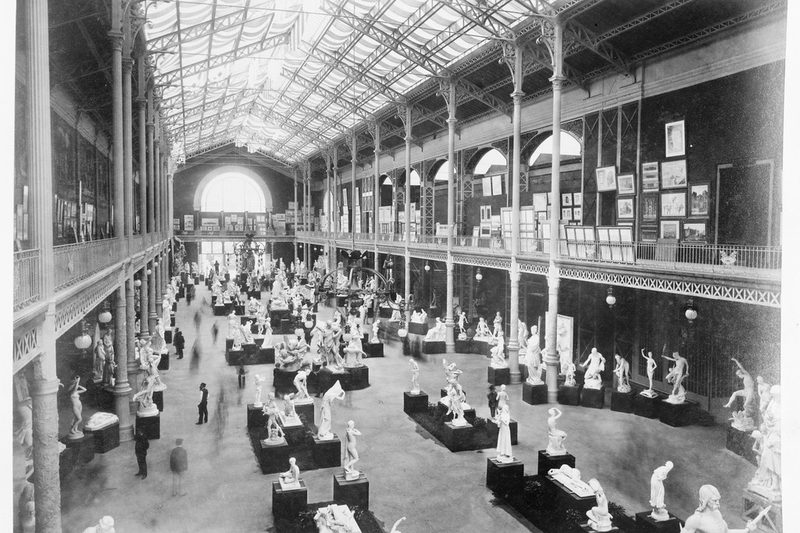 A narrow exhibition hall with display cases along both sides
